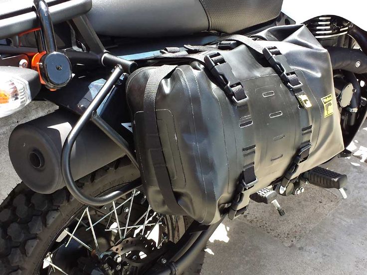 the back end of a motorcycle with luggage strapped to it's front tire carrier