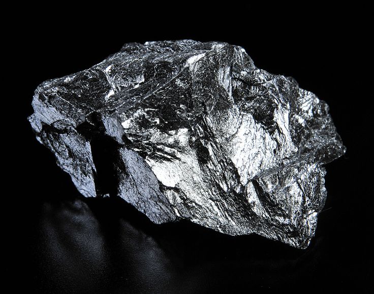 a large piece of silver on a black background