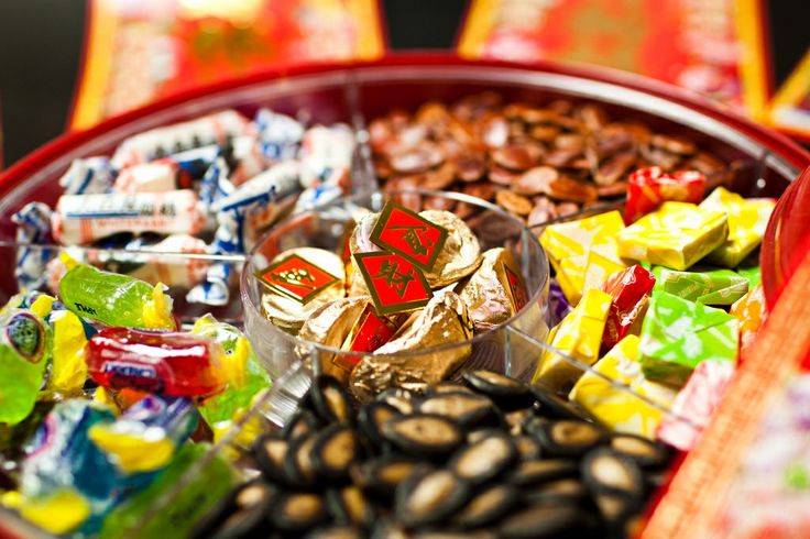 a red tray filled with assorted candy and candies on top of each other