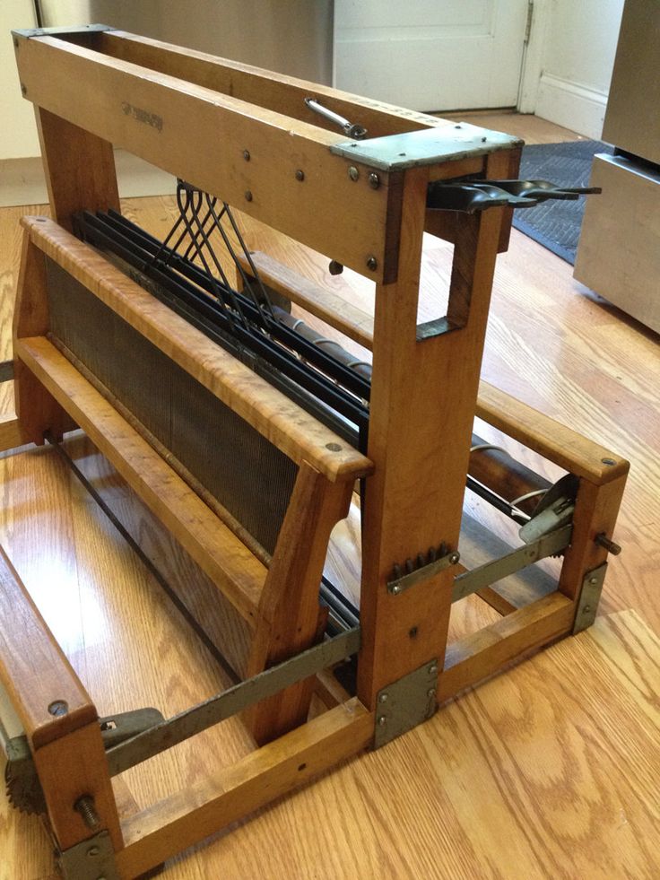 a wooden bench sitting on top of a hard wood floor