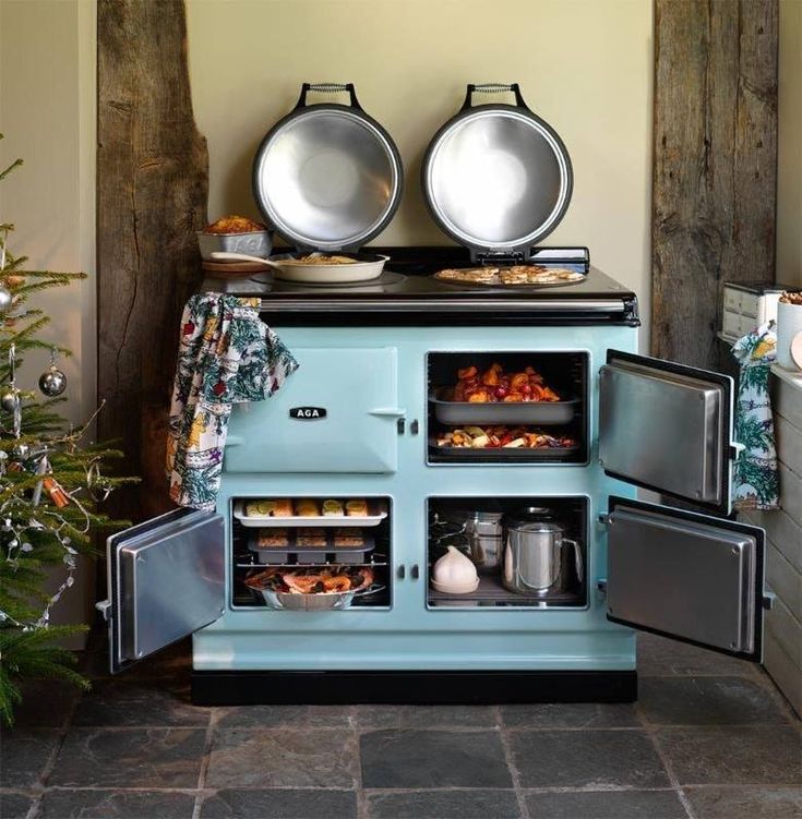 an old fashioned stove with two pots and pans on it's burners