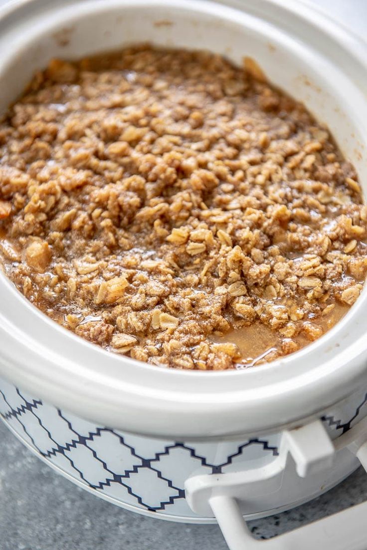 a white bowl filled with oatmeal sitting on top of a table