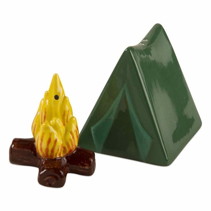 a small yellow and green ceramic object next to a pyramid shaped candle holder on a white background