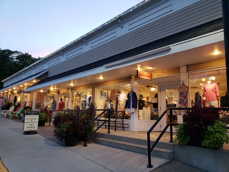 an outside view of a clothing store at dusk