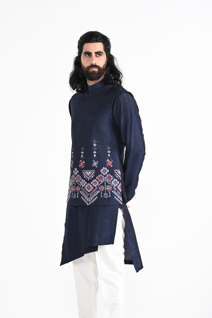 Navy Phulkari inspired Nehru Jacket with pipe, cutdaana and thread work embroidery with overlapping kurta highlighted with embroidery detail on the chest and stitchline border made in Bamberg Raw Silk. Paired with Ivory slim fit Pant Pajama. Color of the actual garment may vary due to lighting conditions during the shoot.
 

Size Chart For Men





	
	
					Men's Size Chart
		

		
		
						
				Size Chart For Men
				Custom Size Measurement Guide
			
			
				
				
				Custom Size Measurement Gui Raw Silk Kurta With Floral Embroidery In Traditional Drape, Designer Floral Embroidery Kurta For Transitional Season, Designer Floral Embroidered Kurta For Transitional Season, Straight Kurta Bandhgala With Floral Embroidery For Eid, Floral Embroidered Bandhgala Straight Kurta For Eid, Eid Bandhgala With Floral Embroidery In Straight Kurta Style, Festive Raw Silk Bandhgala With Floral Embroidery, Festive Bandhgala With Floral Embroidery In Raw Silk, Transitional Bandhgala With Floral Embroidery In Raw Silk