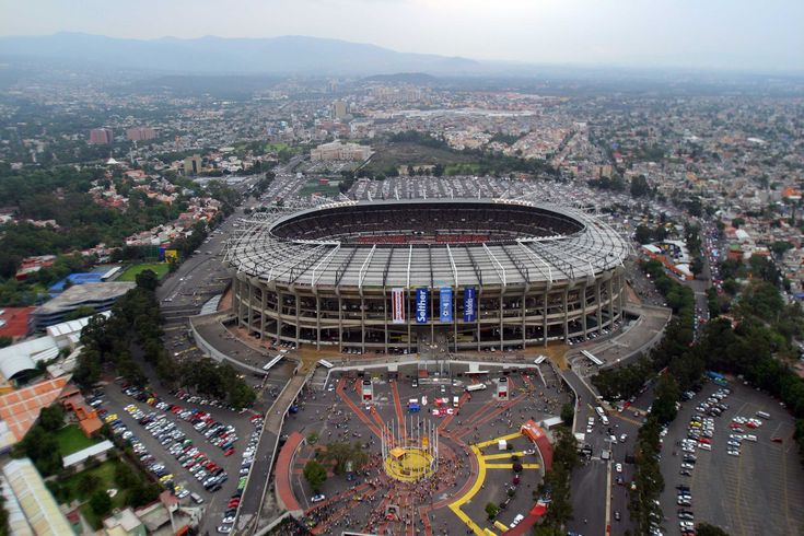 an aerial view of a stadium with cars parked in the lot