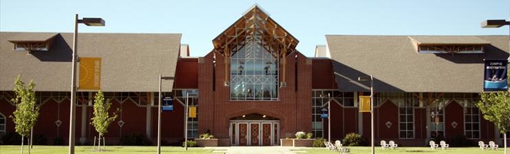 a large building with many windows and flags