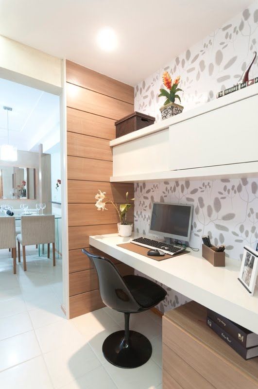 a desk with a computer on top of it in front of a dining room table