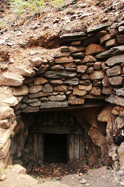 an old stone building with a door in it