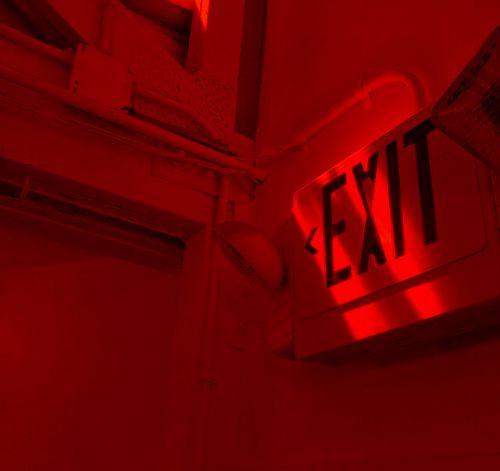 the exit sign is lit up in red light