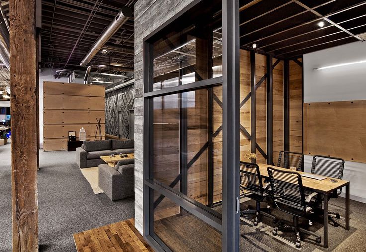 an office with wood paneling and glass walls