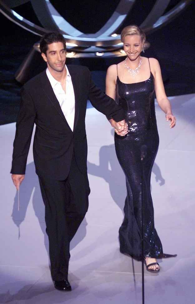 the man and woman are walking down the runway