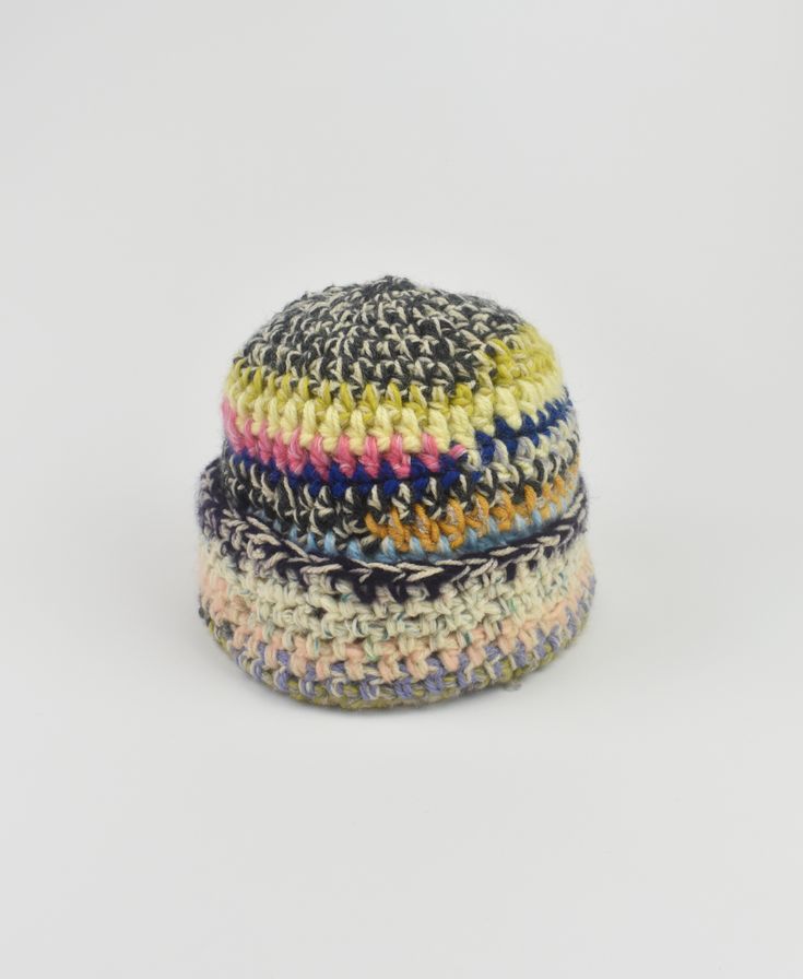 a multicolored crocheted hat on a white background