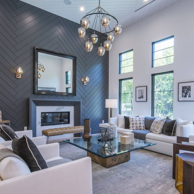 a living room filled with furniture and a fire place in the middle of a room