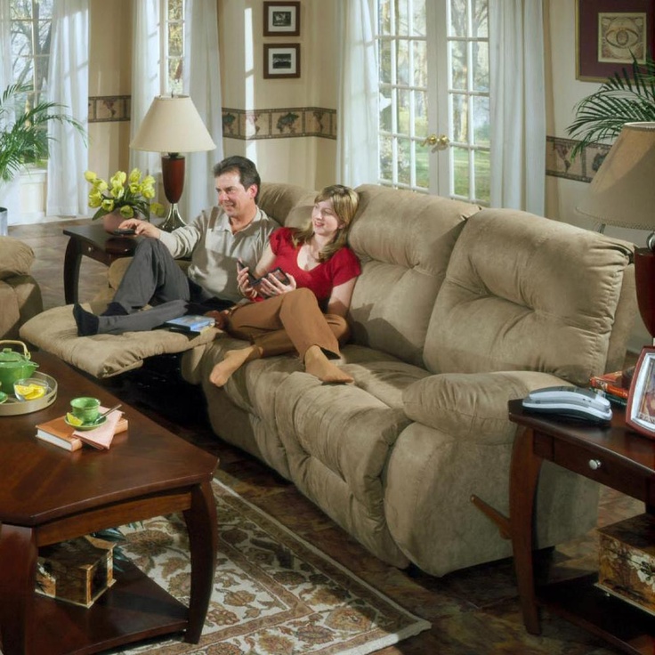 a man and woman sitting on a couch in a living room