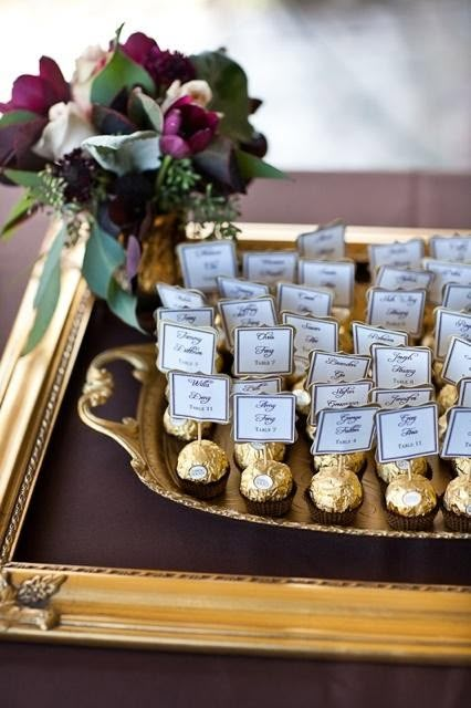 there is a tray with chocolates and flowers on it