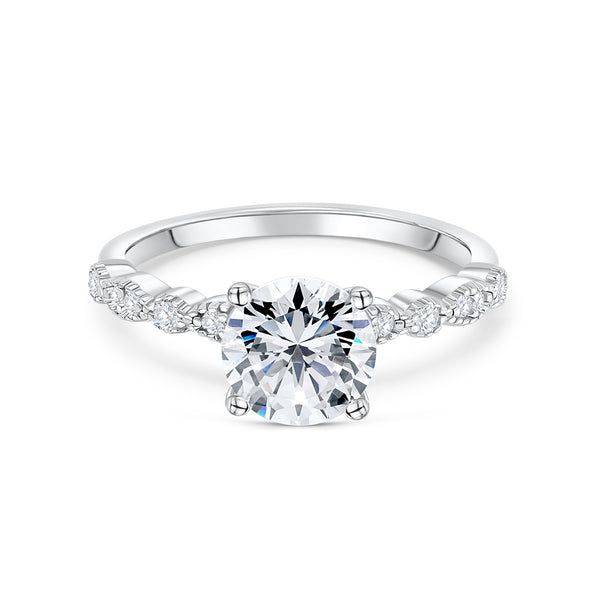 a white gold engagement ring with an oval cut diamond surrounded by pave set diamonds