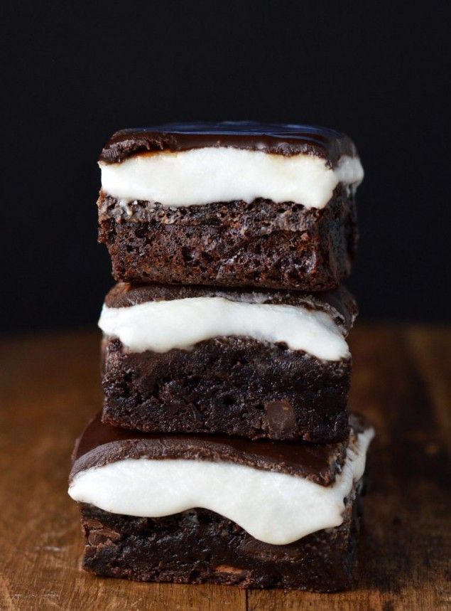 three brownies with white frosting stacked on top of each other