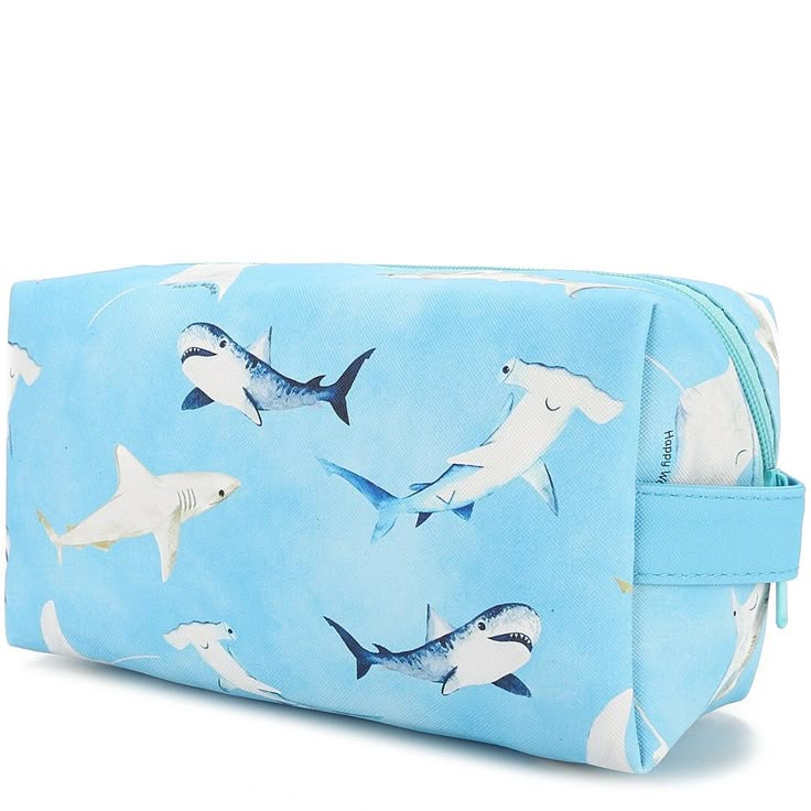 An adorable and square bag to hold all your essentials! Hold makeup, stationery, and more in this pouch and keep your bag organized! The Cosmetic Pouch Happy Sharks Blue is the perfect addition to your bag! Length: 8 inches Width: 4 inches Depth: 3 inches Weight: 0.4 lbs Material: Vegan Leather Rectangular Travel Pencil Case With Zipper, Trendy Rectangular Travel Pencil Case, Blue Large Capacity Pouch For Daily Use, Rectangular Zipper Pouch Cosmetic Bag For School, Blue Rectangular Case Bag For Daily Use, Blue Spacious Pouch For Daily Use, Trendy Blue Rectangular Case Bag, Large Capacity Rectangular Pencil Case For Travel, Blue Rectangular Daily Use Bag