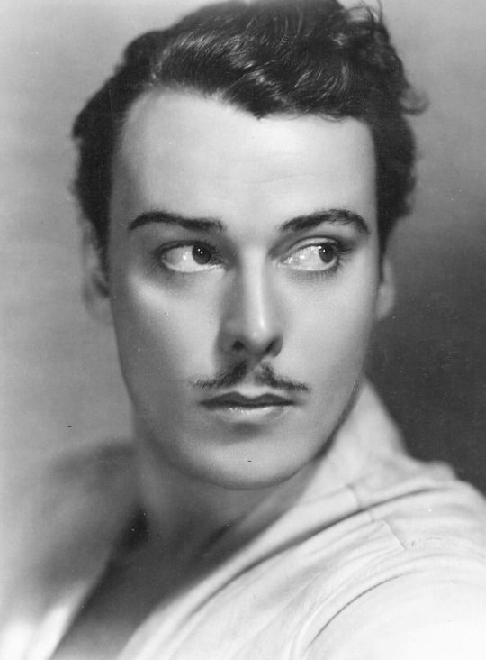 an old black and white photo of a man with a moustache on his face