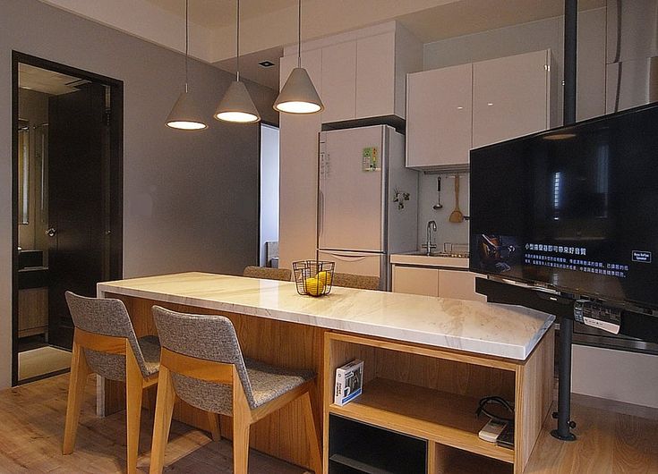 the kitchen is clean and ready to be used for cooking or eating, while the dining table has been set up with four chairs