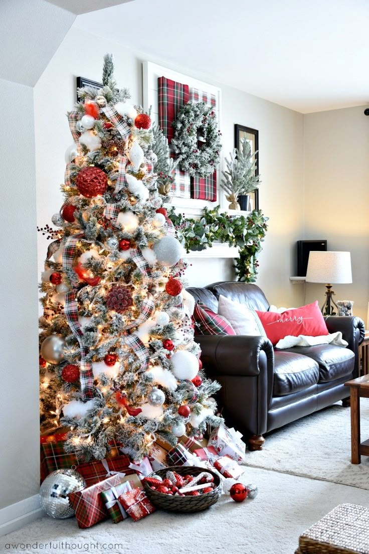 a decorated christmas tree in the corner of a living room