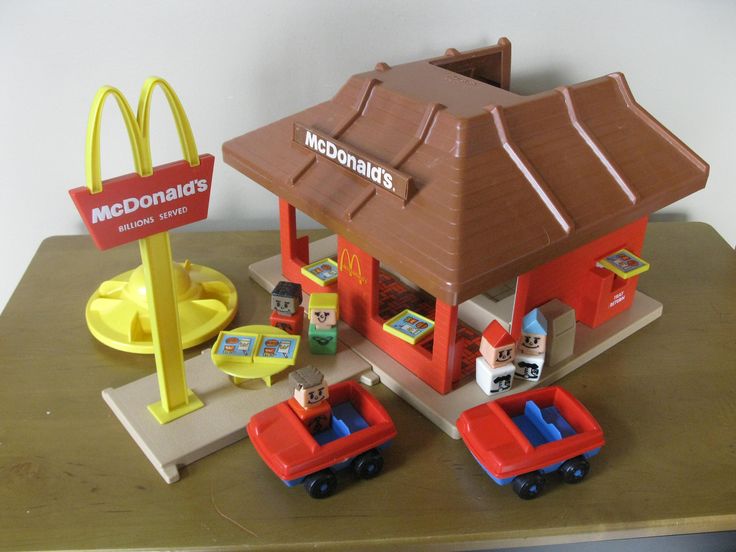 a mcdonald's toy set on a table next to a hot dog stand and other toys