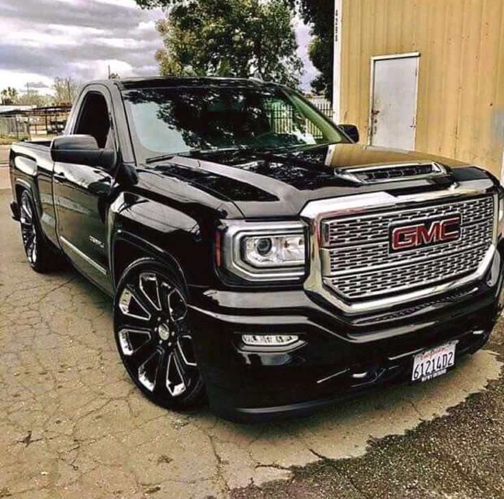 a black truck parked in front of a building