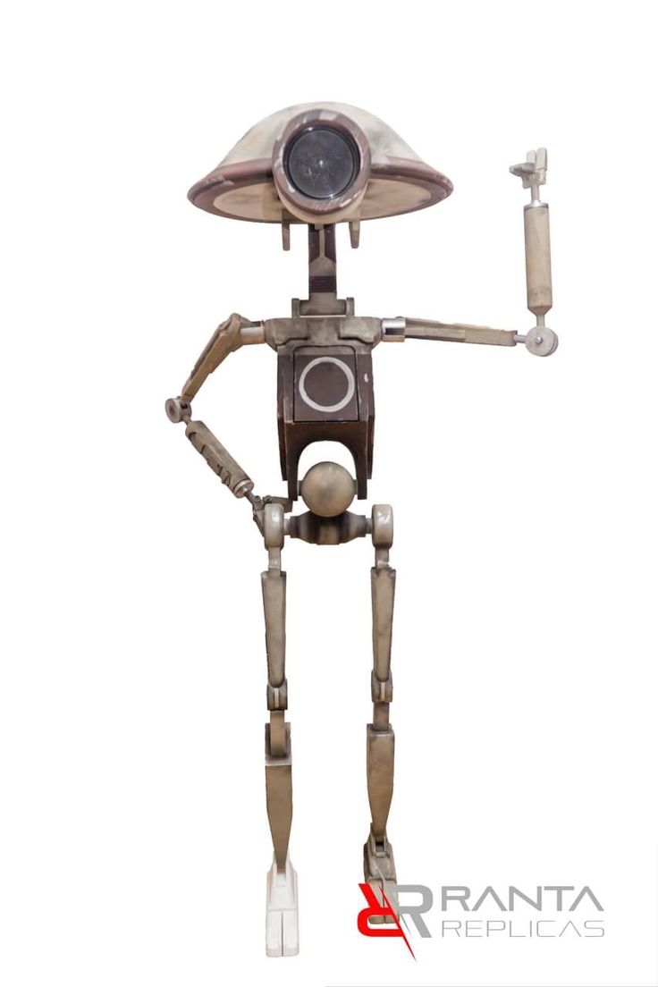 a robot that is standing up with its hands in the air and holding something on his arm