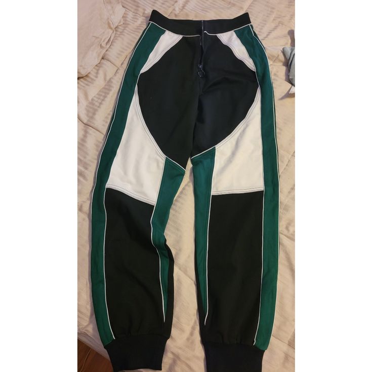 Size Small Womans Pants. Brand New. Tight At Waist And Hips, Loose On Legs, And Then Jogger Style At The Bottom. Has Stretch To It. Cute With A Crop Top And High Heels. Black, Green, And White. Zips Up The Middle. Trendy Green Joggers, Trendy Green Joggers For Streetwear, Green Trendy Streetwear Joggers, Trendy Green Streetwear Joggers, Green Stretch Joggers For Streetwear, Fitted Green Sporty Joggers, Urban Green Joggers For Streetwear, Trendy White Jogging Bottoms, Green Urban Joggers For Streetwear