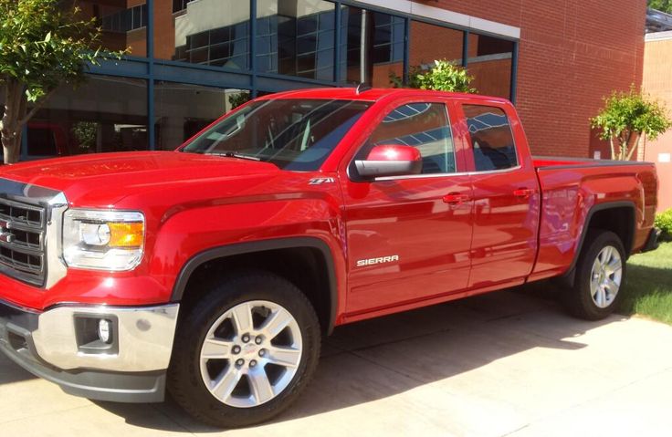 a red truck parked in front of a building