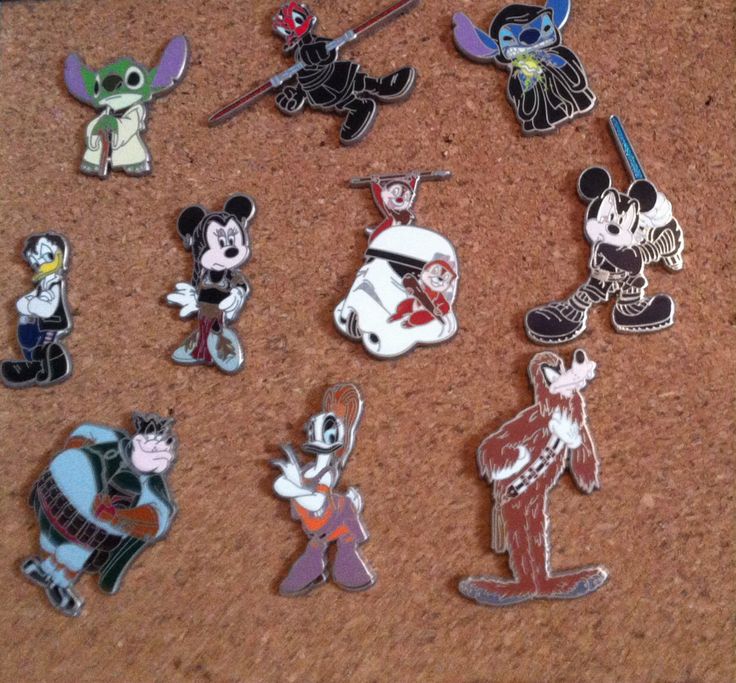 many disney pins are laying on the floor