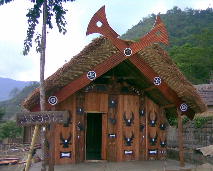 a wooden building with some arrows on it's roof and an arrow pointing to the right