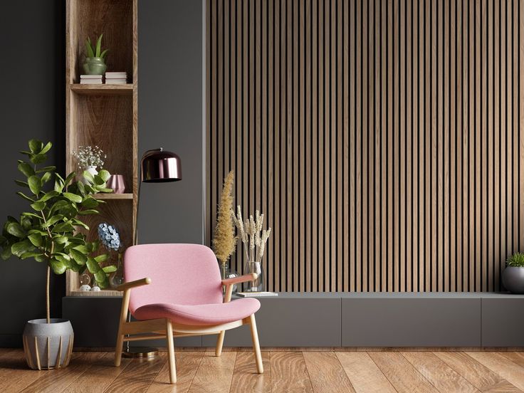 a pink chair sitting in front of a wooden wall