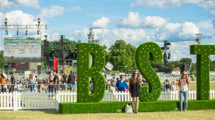 two people standing in front of the letters that spell it's twenty three years