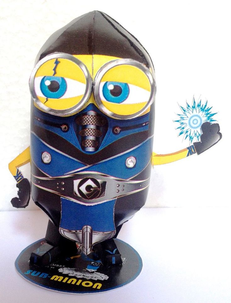 a close up of a toy robot on a white surface with blue and yellow eyes