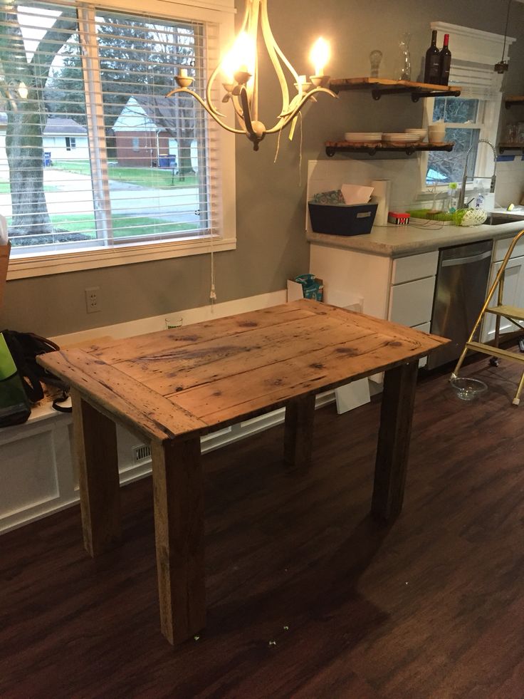 a wooden table sitting on top of a hard wood floor