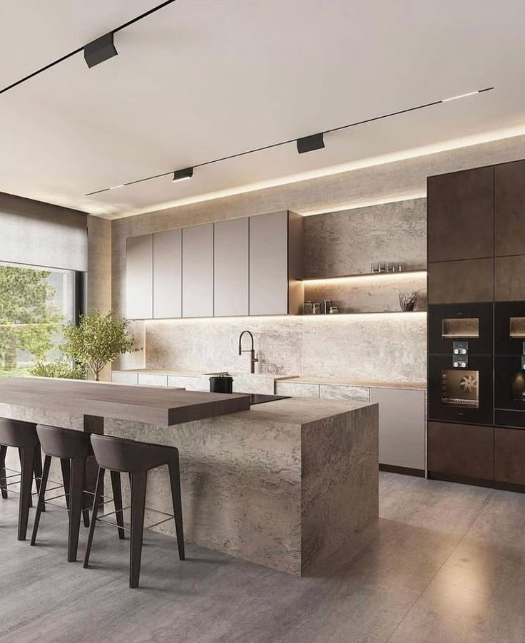 a modern kitchen with an island countertop and bar stools in the middle of it