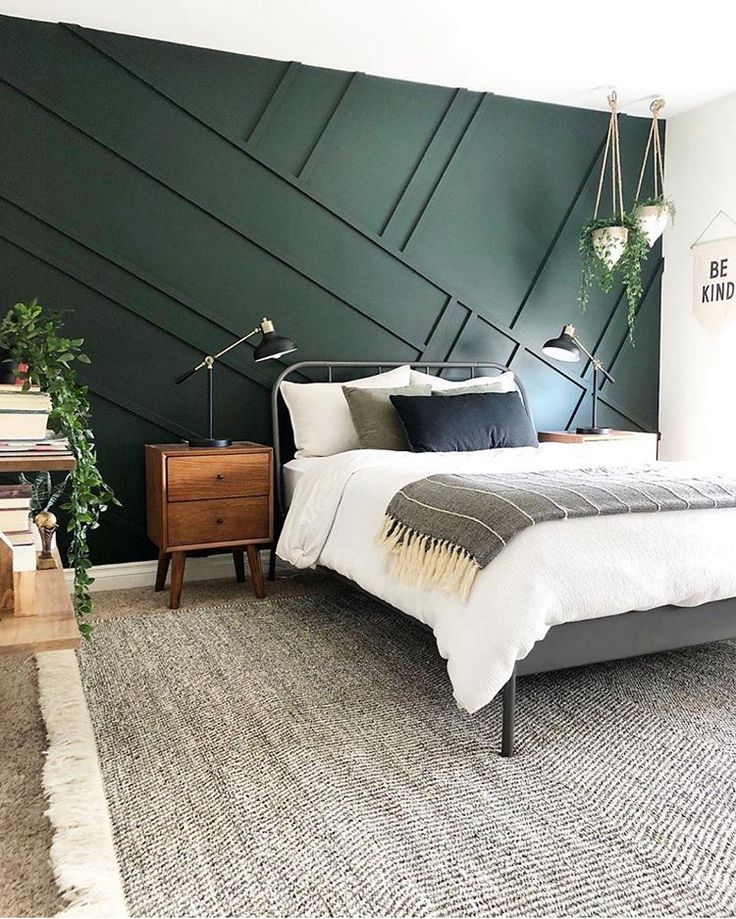 a bed room with a neatly made bed next to a window and a rug on the floor