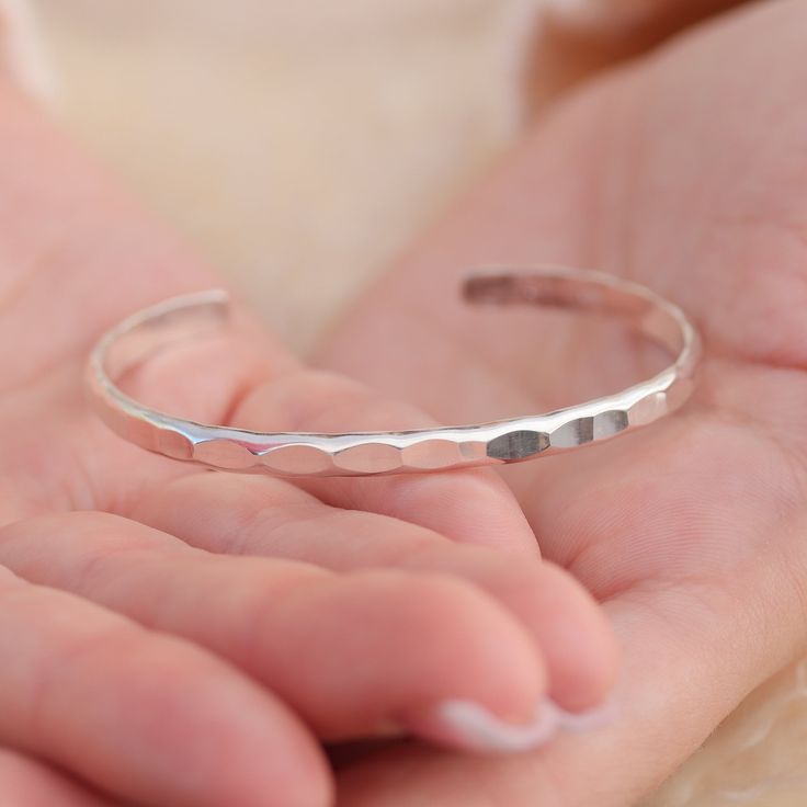 Lotus Stone Jewelry's line of cuff bracelets are custom sized, hand-hammered, and are individually custom sized. Just like faceting a gem, the hammered texture makes the cuffs brilliant, sparkling, and eye-catching. These wide ones are a full 4-4.5mm wide. Sturdy, strong, and bold, these sterling silver bangles are just delightful. Minimalist Hammered Cuff Bracelet As Gift, Minimalist Hammered Cuff Bracelet Gift, Modern Hammered Cuff Bracelet As Gift, Modern Hammered Cuff Jewelry, Hammered Cuff Bracelet As Gift, Minimalist Adjustable Hammered Cuff Bracelet, Hammered Cuff Bangle Bracelet For Gifts, Hammered Bangle Cuff Bracelet As Gift, Adjustable Hammered Cuff Bangle