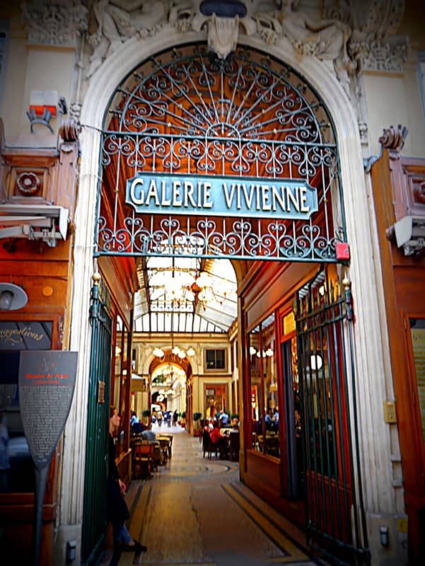 an entrance to a restaurant with people sitting at tables