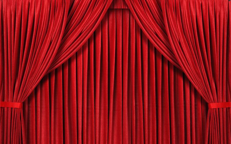 a red curtain is opened to reveal the curtains