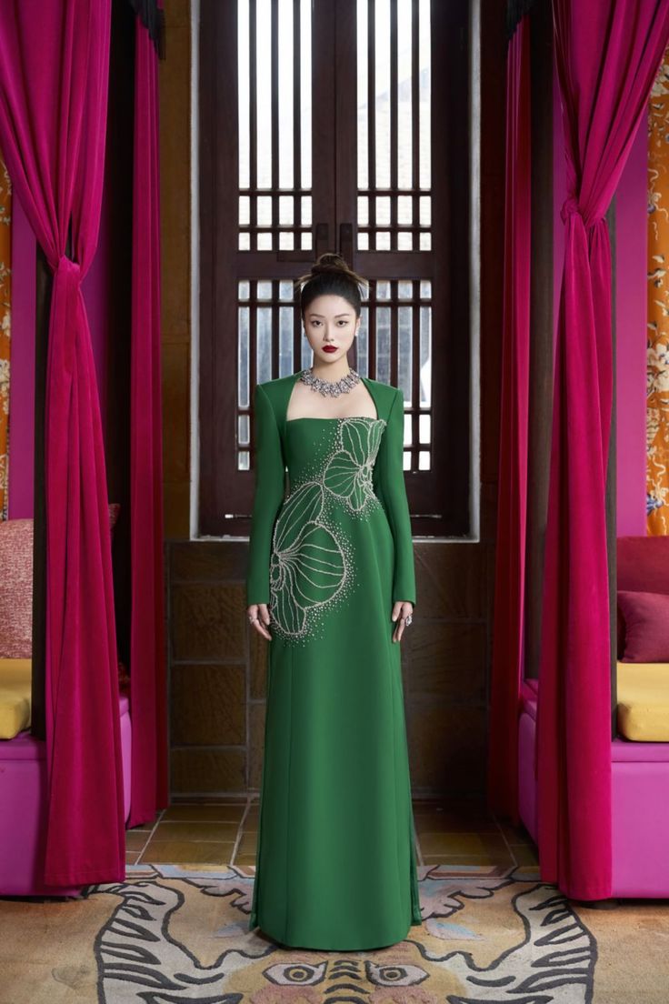 The epitome of luxury and elegance. This Ao Dai is the perfect blend of comfort and sophistication. The smooth velvet and soft satin will make you feel like royalty, while the flattering sheath silhouette highlights your figure. Elevate your style with Vivacy. Length: 150cm (Ao Dai), 110cm (Pants) Luxury Floor-length Evening Dress, Luxury Festive Evening Dress With Fitted Bodice, Luxury Ball Gown For Banquet, Luxury Festive Evening Dress, Luxury Festive Gown With Fitted Bodice, Elegant Floor-length Evening Dress For Ceremony, Luxury Green Gown For Banquet, Luxury Gown For Ceremonies, Luxury Satin Gown For Banquets