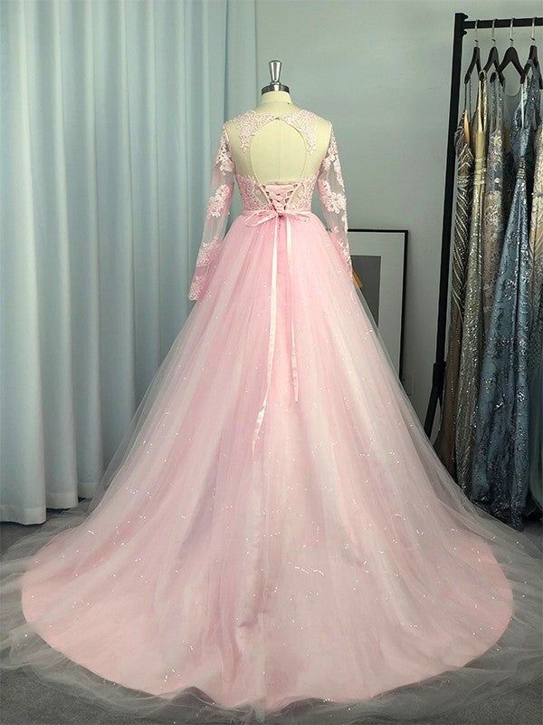 Neckline: JewelSilhouette: Ball GownBuilt-in Bra: YesSleeve: Long SleevesWaist: NaturalBack Style: Lace UpHemline/Train: Sweep/Brush Train Long Sleeve Ball Gown For Quinceanera And Prom Season, Long Sleeve Gown With Sheer Bodice For Prom, Pink Dress With Sheer Bodice For Quinceanera, Princess Style Long Sleeve Banquet Dress, Long Sleeve Prom Gown With Sheer Bodice, Long Sleeve Lace Gown With Sweep Train, Long Sleeve Tulle Ball Gown For Wedding, Pink Long Sleeve Ball Gown For Prom, Long Sleeve Tulle Dress For Debutante Ball