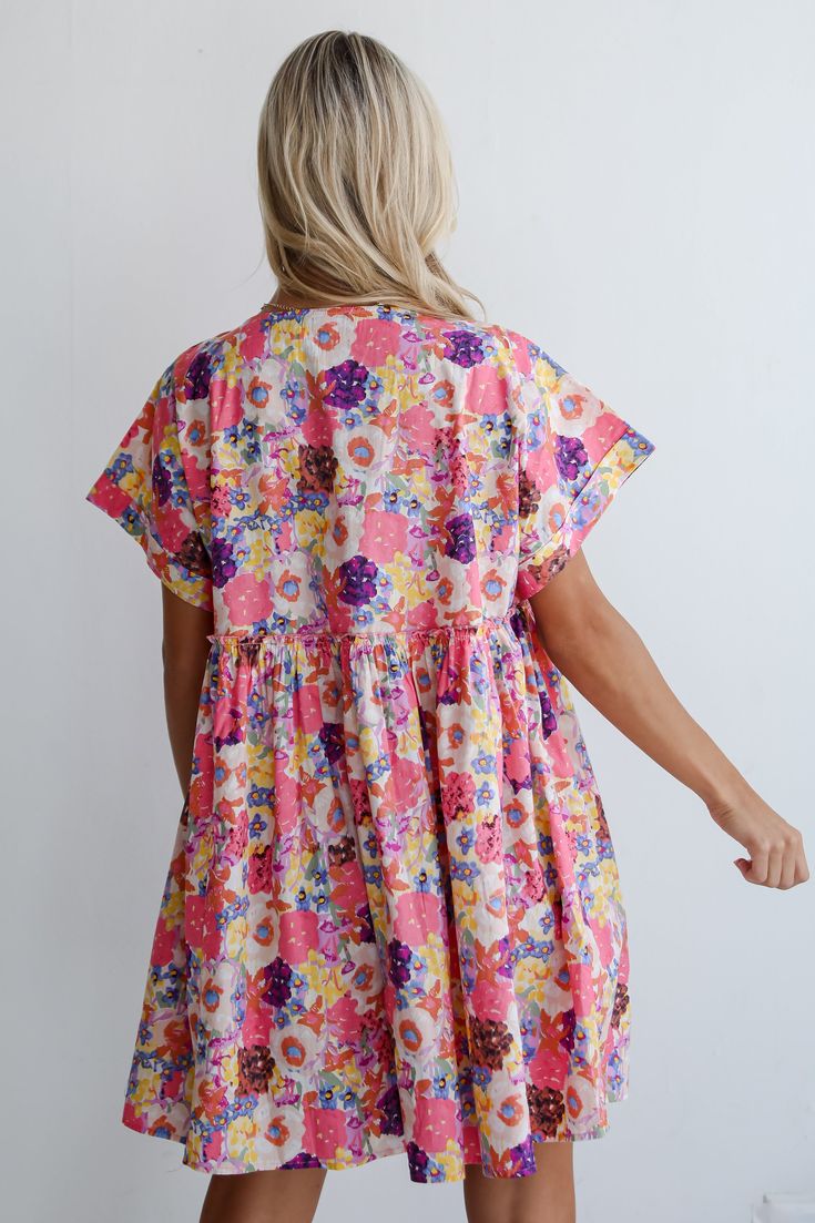 A look like the Lovely Muse Pink Floral Babydoll Mini Dress will have everyone who sees you swooning! Crafted from lightweight fabric, this dress combines comfort with effortless style, making it perfect for sunny days and casual outings. This floral motif adds a fresh and cheerful touch, enhancing the dress's overall appeal and creating a captivating visual contrast against the pink backdrop. Designed in a babydoll silhouette, the dress offers a relaxed fit with a gathered empire waistline that Playful Short Sleeve Dresses For Brunch, Playful Cotton Loungewear Dress, Playful Smocked Summer Dresses, Playful Summer Smock Dress, Cotton Smock Mini Dress For Daywear, Cotton Smock Mini Dress For Brunch, Cute Smocked Short Sleeve Dresses, Floral Print Short Sleeve Sundress For Daywear, Short Sleeve Smock Dresses For Day Out