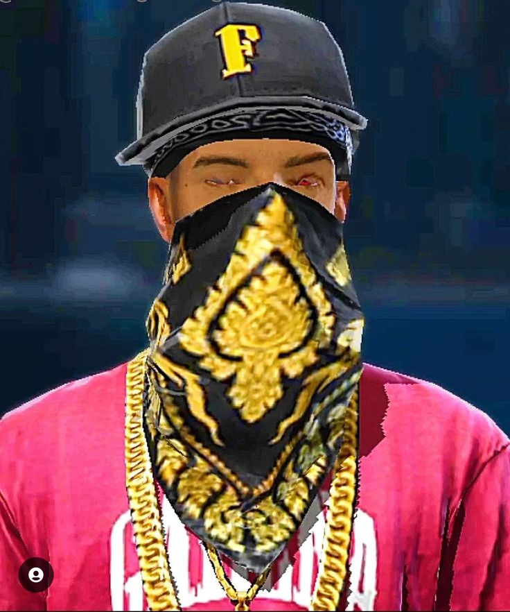 a man wearing a black hat and bandana with gold designs on it's face