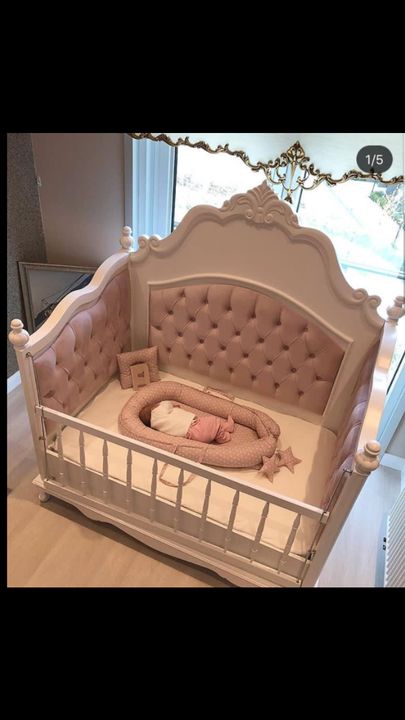 a baby crib that is in the middle of a room