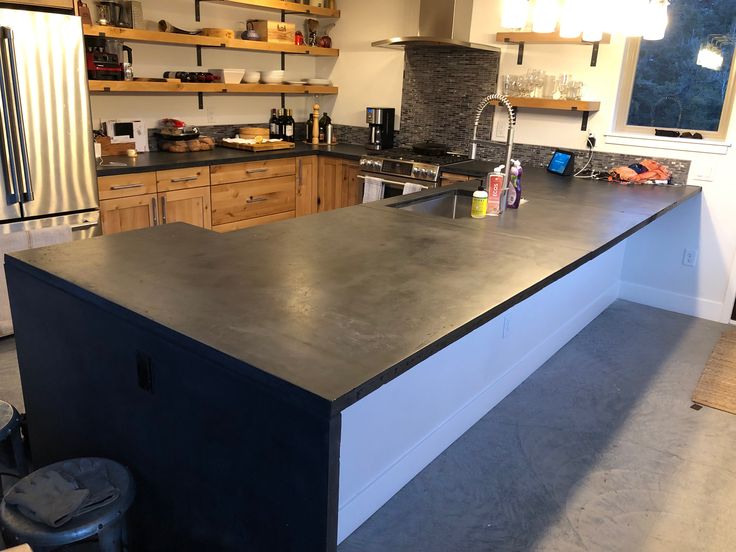 a kitchen with an island counter top in the middle