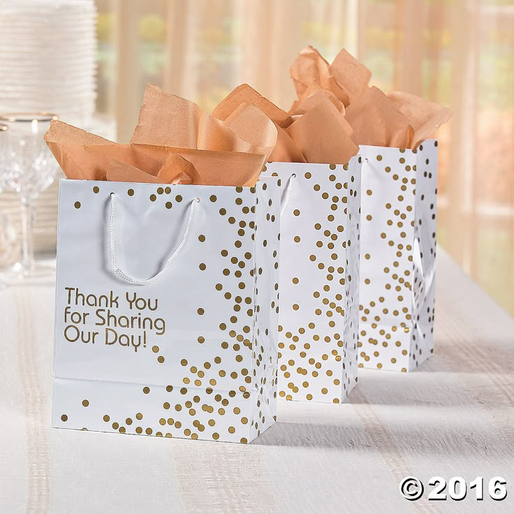 three bags with thank you for sharing our day written on them sitting on a table