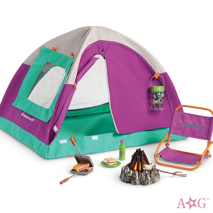 a purple and green tent with camping gear in it's back pocket, next to an open fire pit